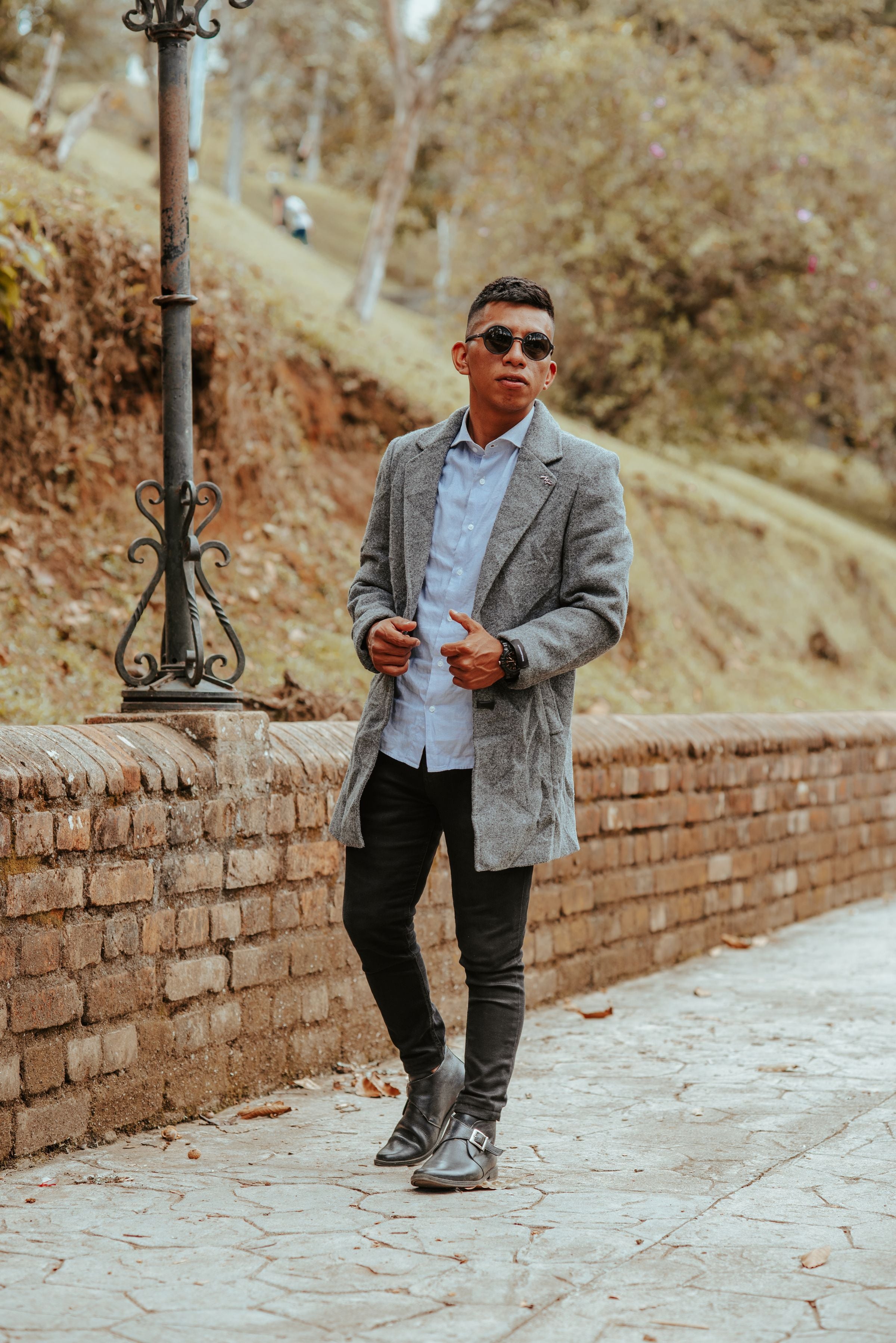 Darkhill — Grey overcoat over light shirt on autumn stone lane — warm neutral street style