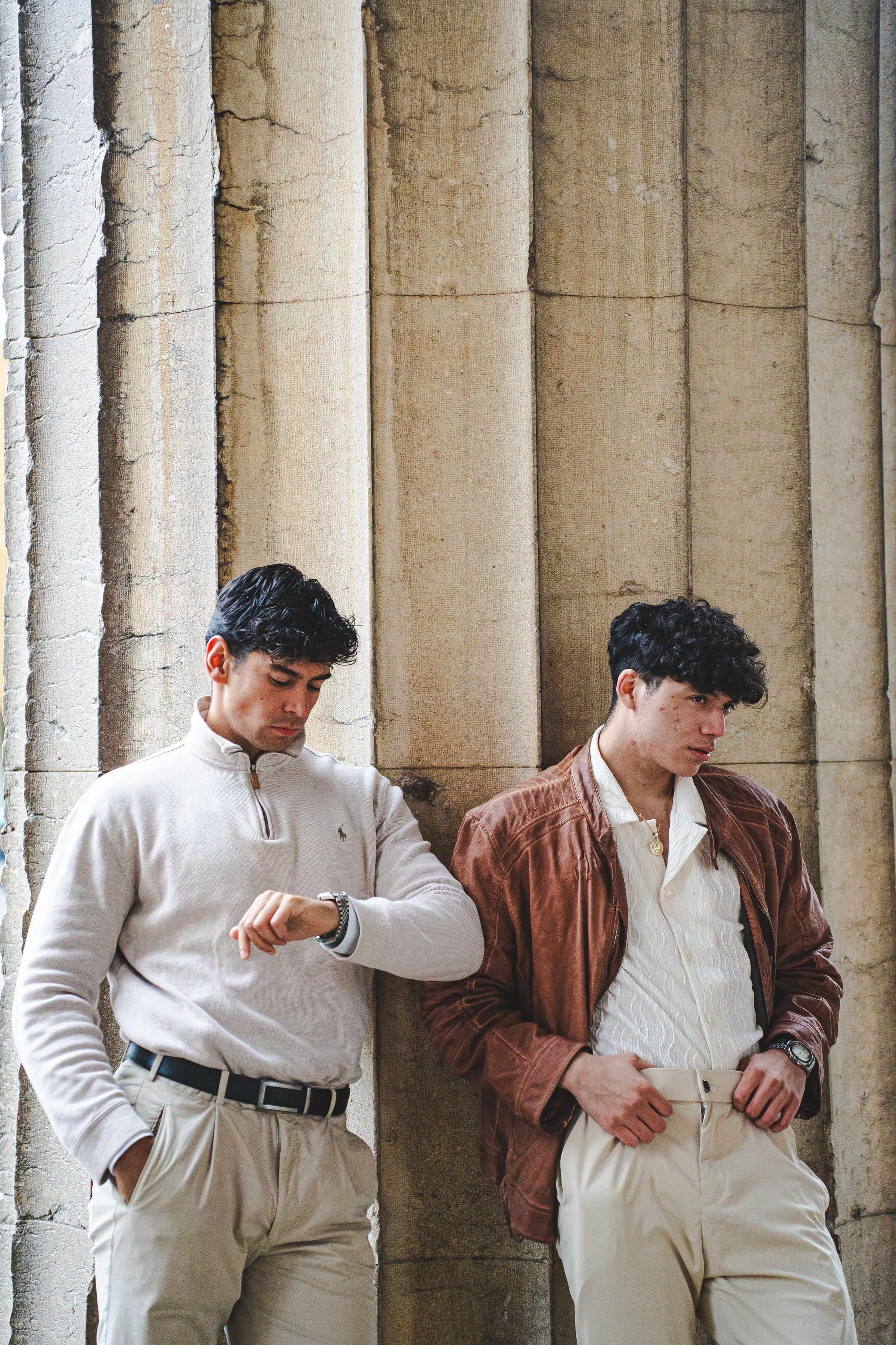 Darkhill — Duo in cream/brown tailored looks between classical columns — cohesive warm pale